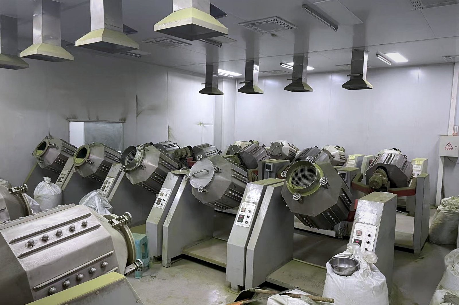 Freshly picked tea leaves being loaded into a steaming machine