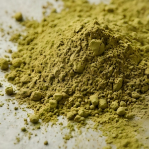 Close-up of coarse industrial matcha powder texture, suitable for blending into supplements and solid beverages.