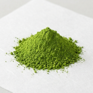 A pile of premium ceremonial grade matcha powder on white paper showing bright green color and smooth consistency for wholesale.