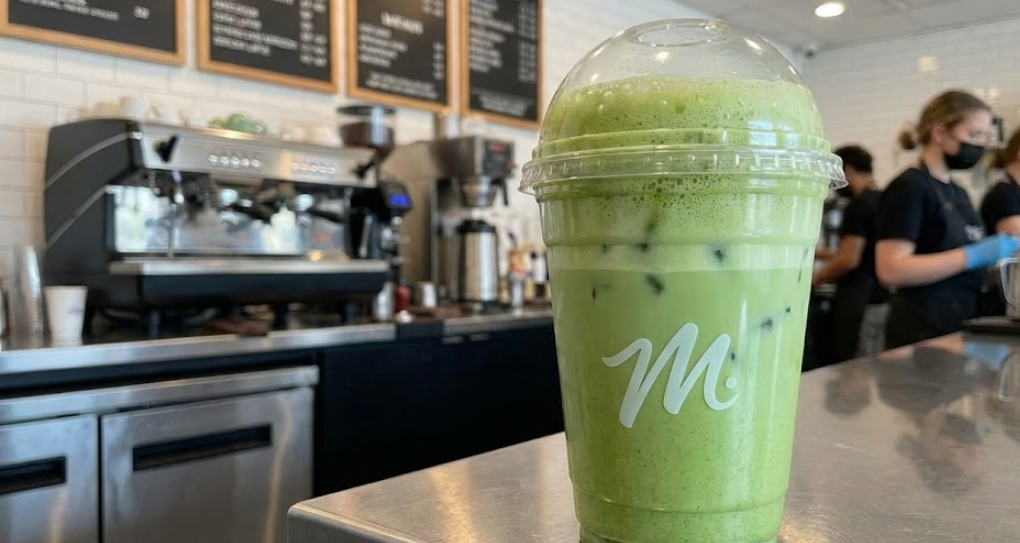 A fast-food style cup with a matcha latte inside
