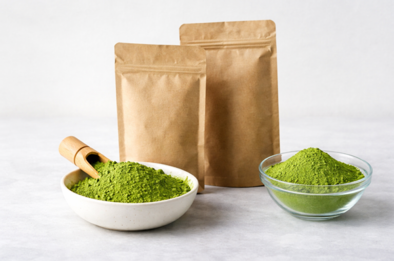 Bulk matcha powder in kraft bags with bowls of green tea powder