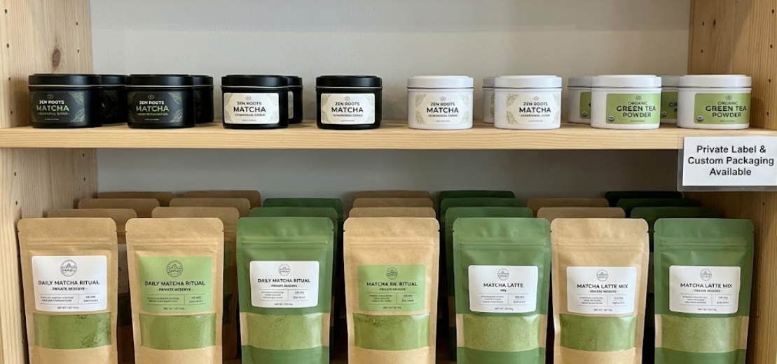 Retail display of private label matcha tins and pouches.