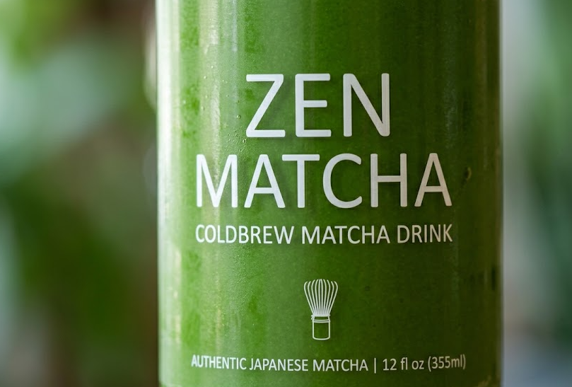 A close-up of a vibrant green ready-to-drink matcha beverage in a clear bottle, showcasing its smooth texture.